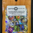 Package of ‘BATTLE BAUBLES Handcrafted Tokens for Dungeons & Dragons,’ featuring 12 colorful class tokens. Each token displays a unique symbol representing different D&D classes, such as a shield, an axe, and a spellbook. The packaging includes a clear plastic cover with a cardboard top displaying the product name and a pixelated image of a shield and crossed swords.